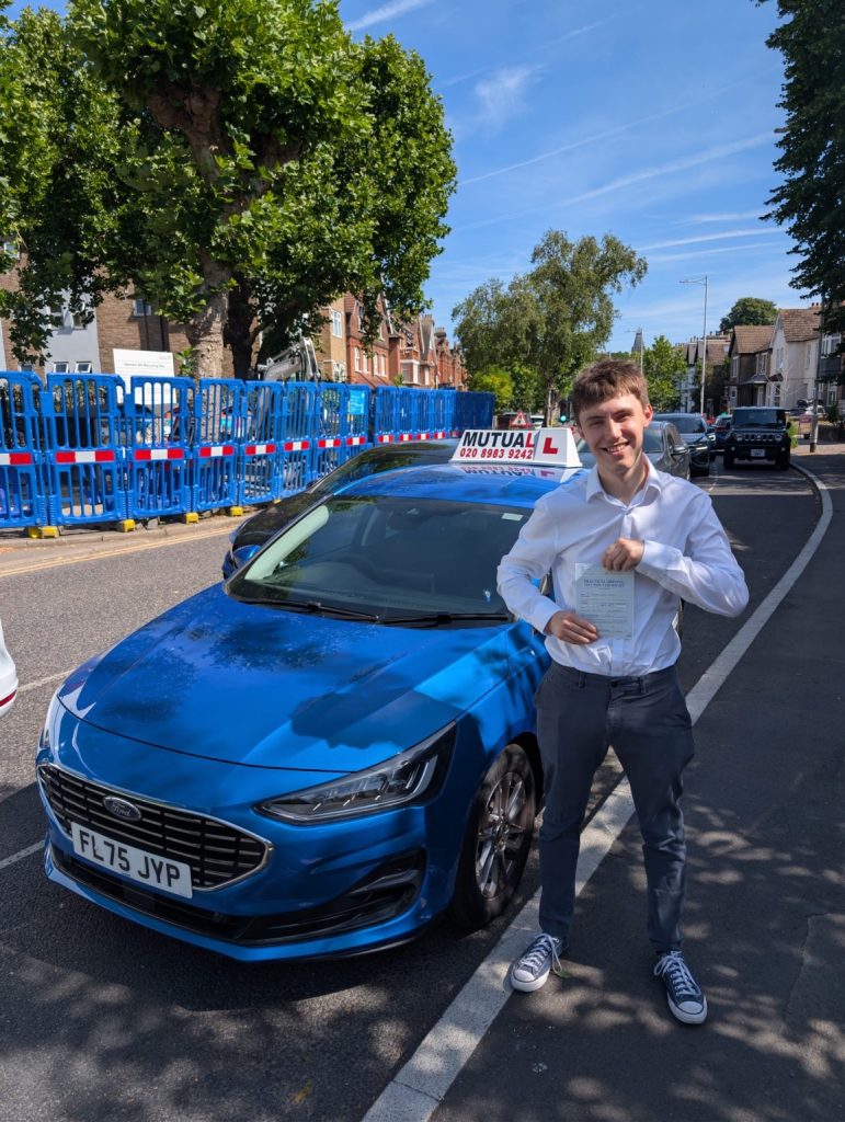 Mutual Driving School pupil celebrating a driving test pass